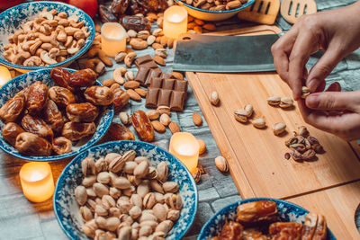Cropped hands of person preparing food on table