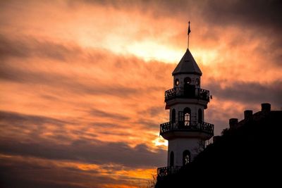 Low angle view of bell tower against sky during sunset