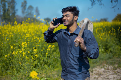 Full length of young man standing on field