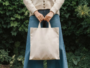 Low section of woman holding gift