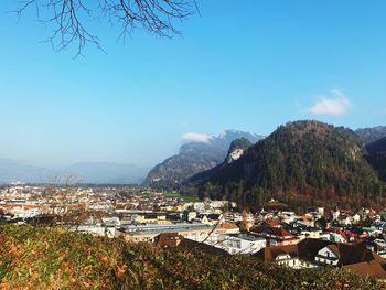 Townscape by mountains against sky