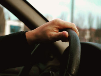Close-up of man hand on window