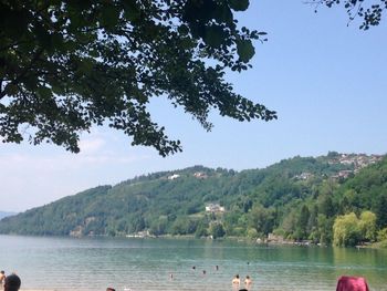 Scenic view of lake and mountains against clear sky