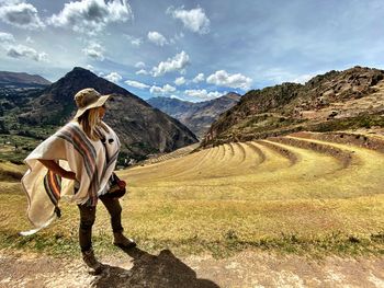 Full length of man standing on landscape against sky