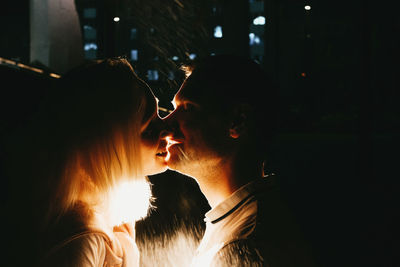 Couple kissing while at night