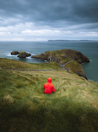 Rear view of woman on mountain against sky