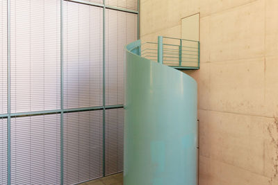 Empty chairs against wall in building