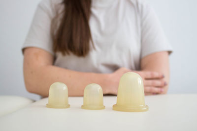 Close-up of woman sitting on table