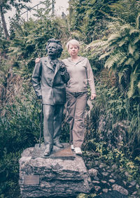 Portrait of friends standing against trees
