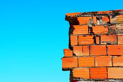 Low angle view of stack against clear blue sky