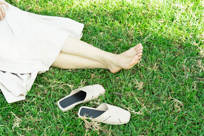 Low section of woman on field