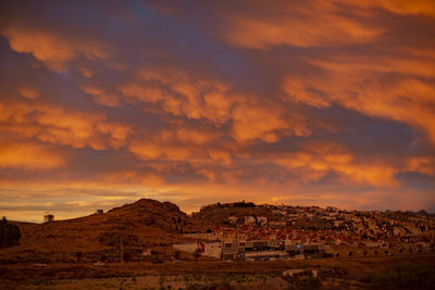 Townscape against sky during sunset