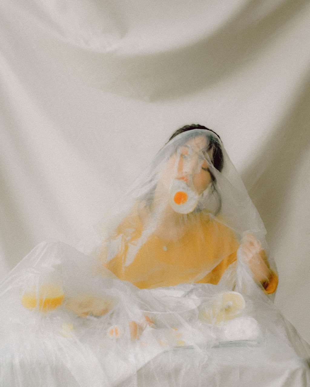 no people, indoors, close-up, plastic, still life, representation, high angle view, human representation, textile, white color, transparent, art and craft, plastic bag, healthcare and medicine, paper, food, single object, wrapped, yellow, food and drink, polythene, veil