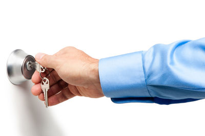 Close-up of man holding camera over white background