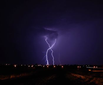 Lightning over landscape at night