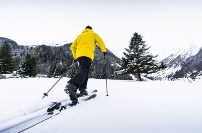 Man skiing against clear sky during winter