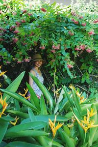 Portrait of woman with pink flowering plants