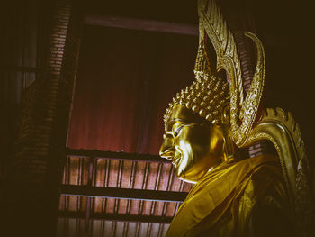 Statue of buddha against building