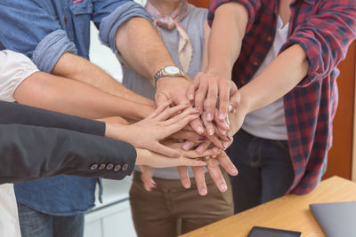 Midsection of couple holding hands