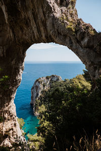 Scenic view of sea seen through rock formation