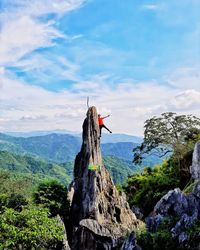 Traditional windmill on mountain against sky