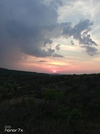 Scenic view of field against sky during sunset