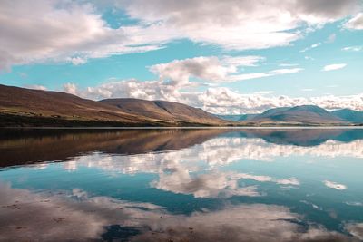 Scenic view of lake and mountains against sky