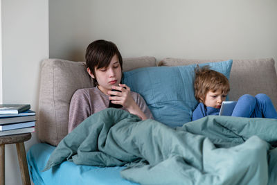 Friends relaxing on sofa at home