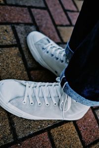 Low section of person standing on tiled floor