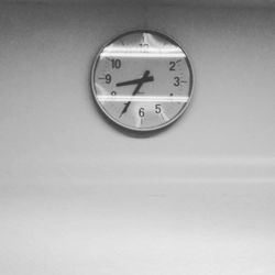 Close-up of clock over white background