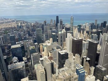 Aerial view of modern buildings in city against sky