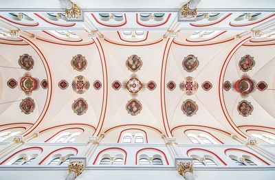 Low angle view of ornate hanging on ceiling of building