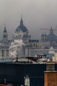 Historic cathedral in city against sky during winter