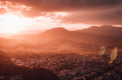 High angle shot of townscape against sky at sunset