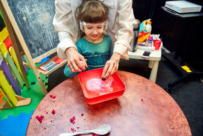 High angle view of boy playing on table