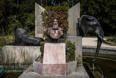 Statue against trees and plants