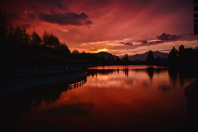 Scenic view of lake against orange sky