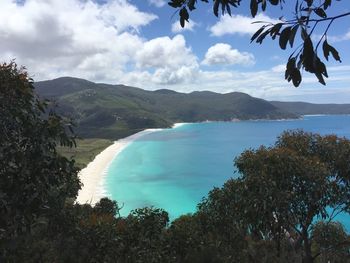 Scenic view of sea and mountains against sky