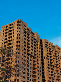 Low angle view of building against blue sky