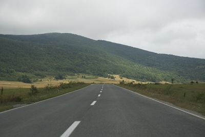 Empty road along landscape