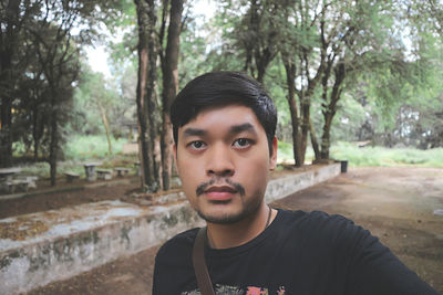 Portrait of young man in forest