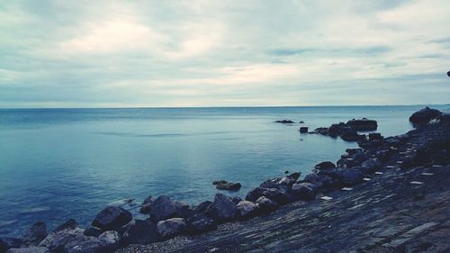 Scenic view of sea against cloudy sky