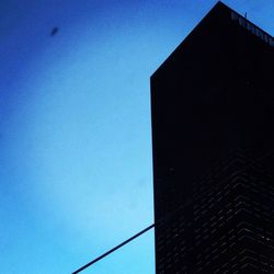 Low angle view of building against clear blue sky