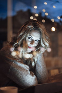 Portrait of young woman sitting outdoors