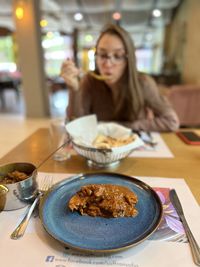 Portrait of woman having food at restaurant