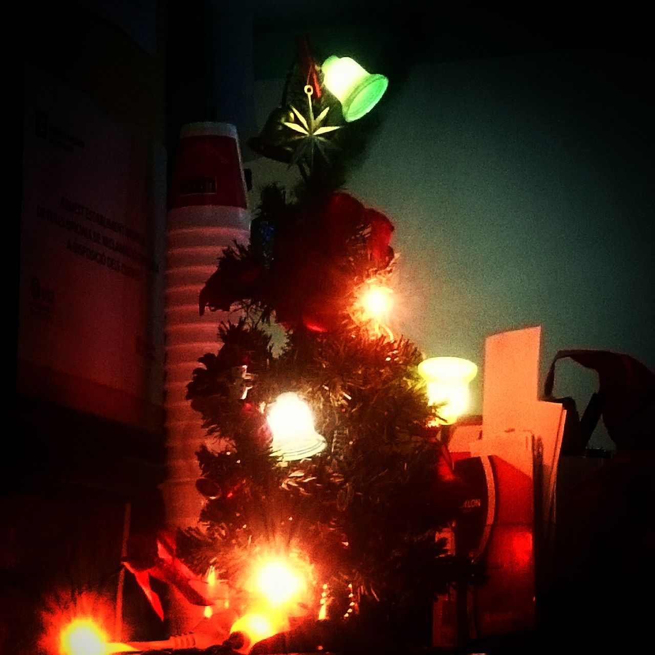 CLOSE-UP OF ILLUMINATED CHRISTMAS TREE AGAINST SKY