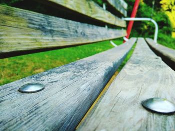 Close-up of wooden bench on table