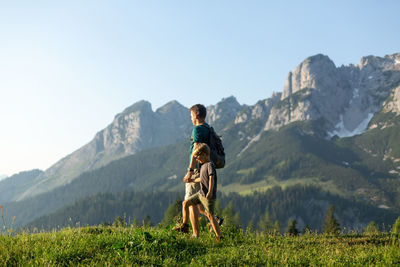 Father and son exploring mountains. hiking outdoor concept