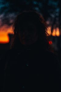 Portrait of woman standing against sky during sunset