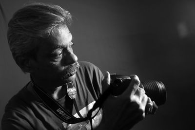 Portrait of man holding camera